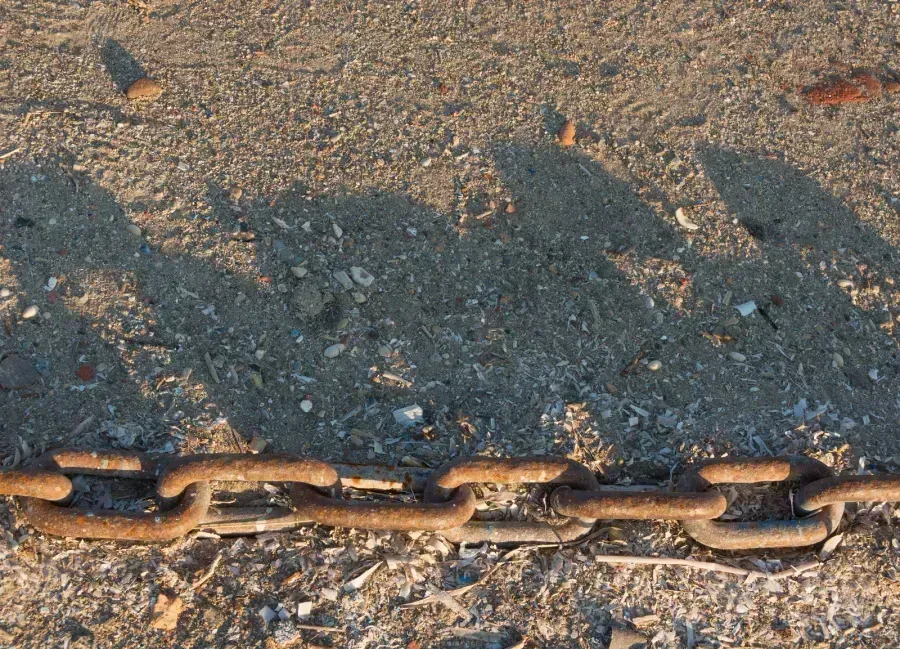 Close-up detail of anchor chain links showing the perpendicular crossbars and geometric construction